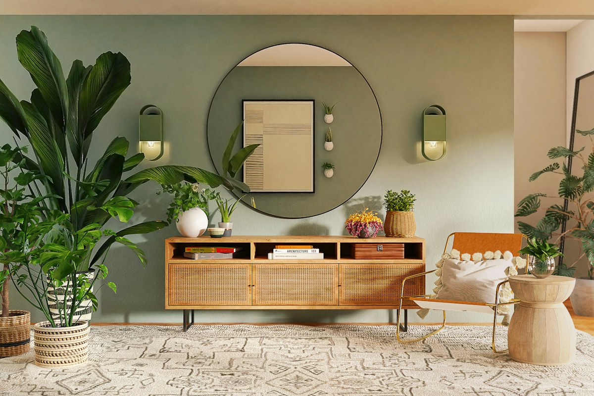 Wooden chairs beside a sideboard, plants and a round wall mirror