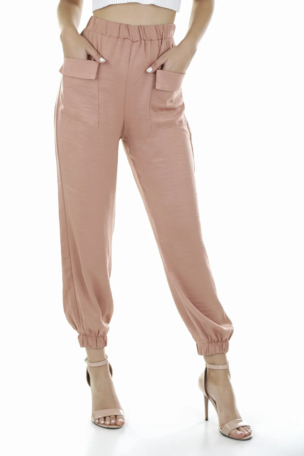 Pale pink trousers shown against a plain light background