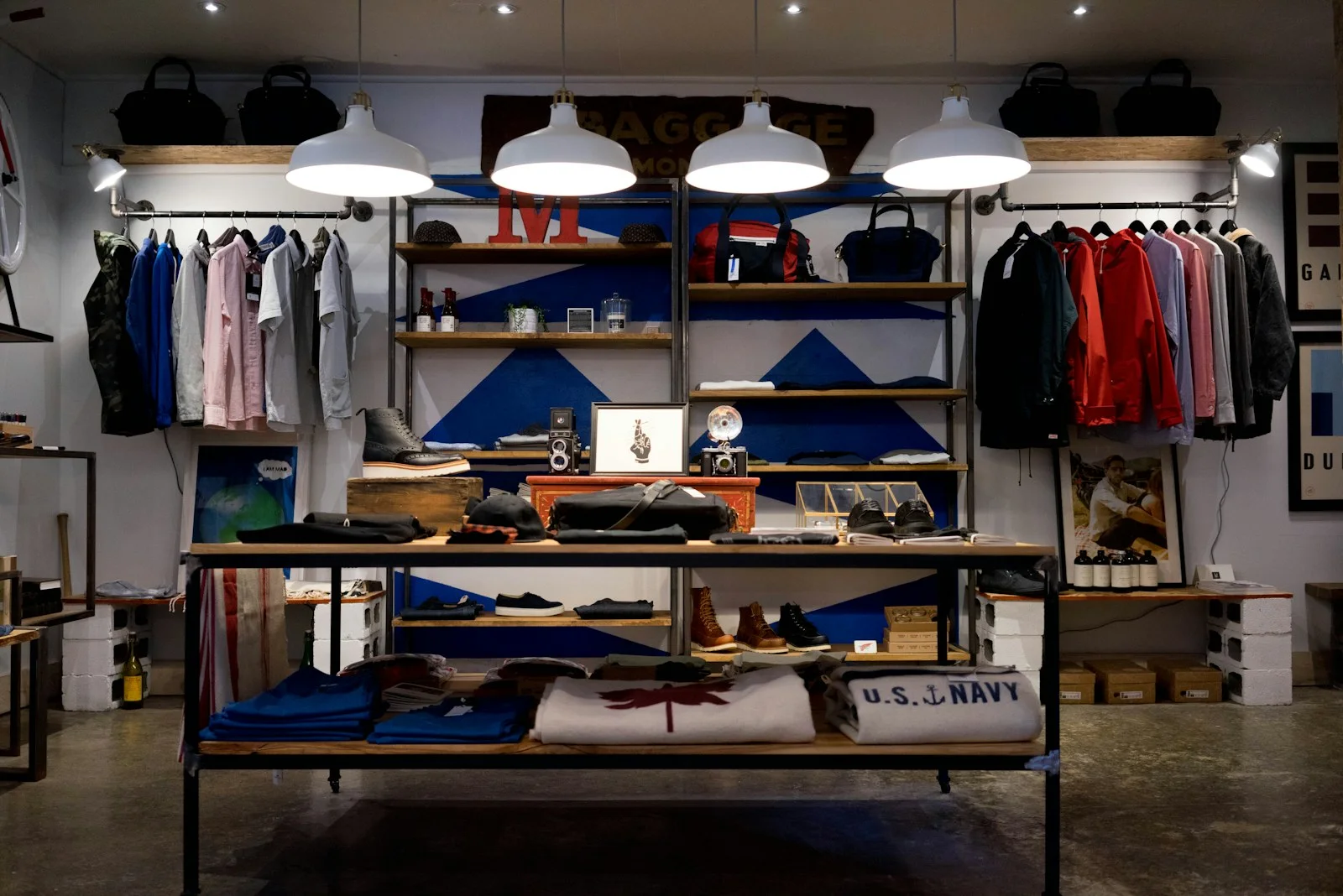 Clothing displayed on rails and shelves inside a fashion shop