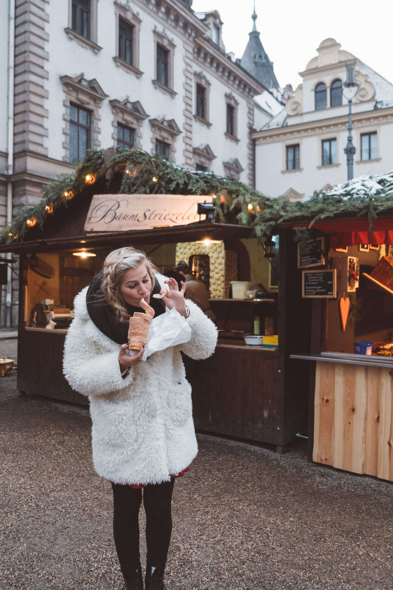 blonde eating chimney cake in regensburg